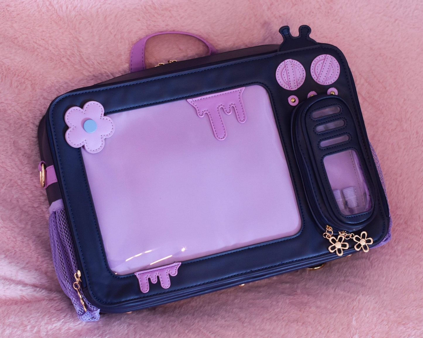 Late Night TV Head Ita Bag 2.0 in black and purple vegan leather with padded pockets and mesh water bottle sides